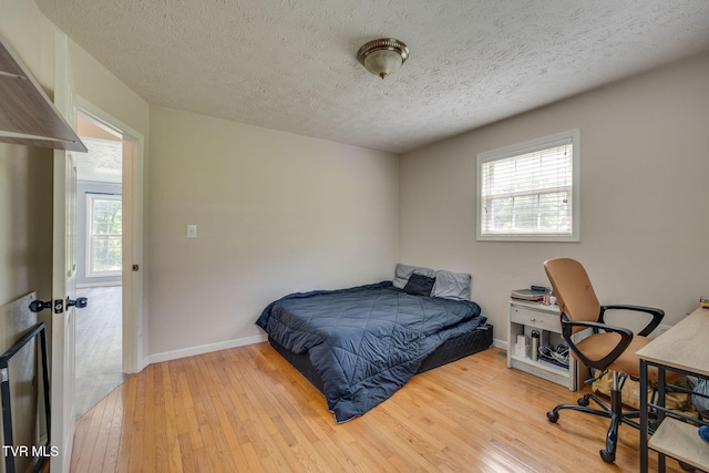 23270 Denton Valley Rd, Abingdon, VA 24211 - bedroom with multiple windows, hardwood / wood-style flooring, a textured ceiling, baseboards, and a desk