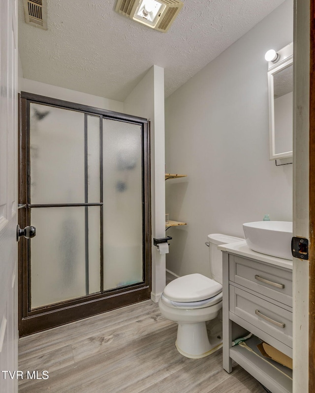 23270 Denton Valley Rd, Abingdon, VA 24211 - full bath with vanity, wood finished floors, a stall shower, toilet, and a textured ceiling