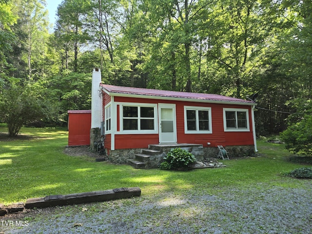 1510 Rock Creek Rd, Erwin, TN 37650 - view of front facade featuring entry steps, a chimney, a front lawn, and metal roof