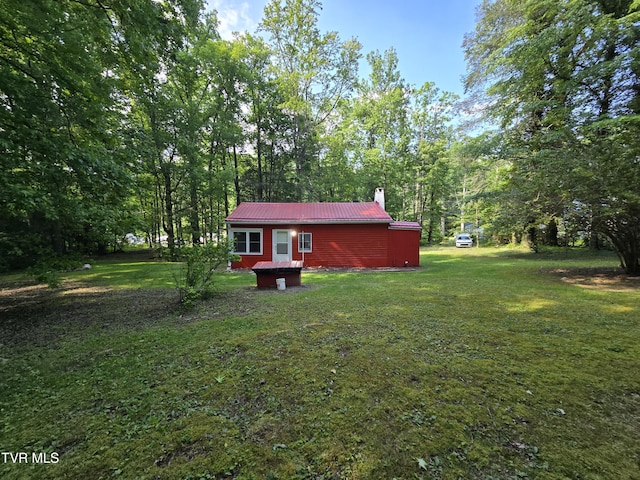 1510 Rock Creek Rd, Erwin, TN 37650 - rear view of property with a chimney, a yard, and metal roof