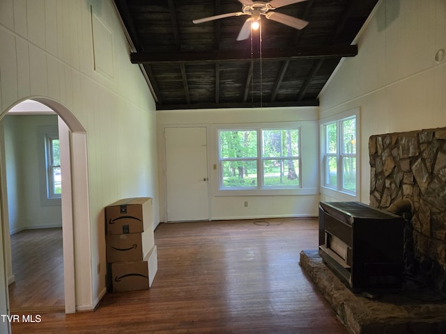 1510 Rock Creek Rd, Erwin, TN 37650 - living room featuring a wood stove, wood finished floors, arched walkways, a ceiling fan, and high vaulted ceiling