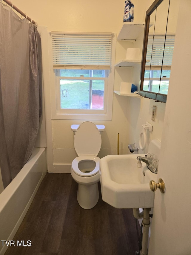 1510 Rock Creek Rd, Erwin, TN 37650 - bathroom featuring plenty of natural light, toilet, wood finished floors, and shower / bath combo with shower curtain