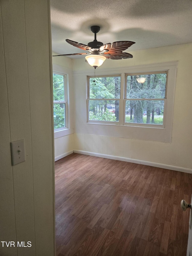 1510 Rock Creek Rd, Erwin, TN 37650 - unfurnished room featuring wood finished floors, a textured ceiling, baseboards, and a ceiling fan