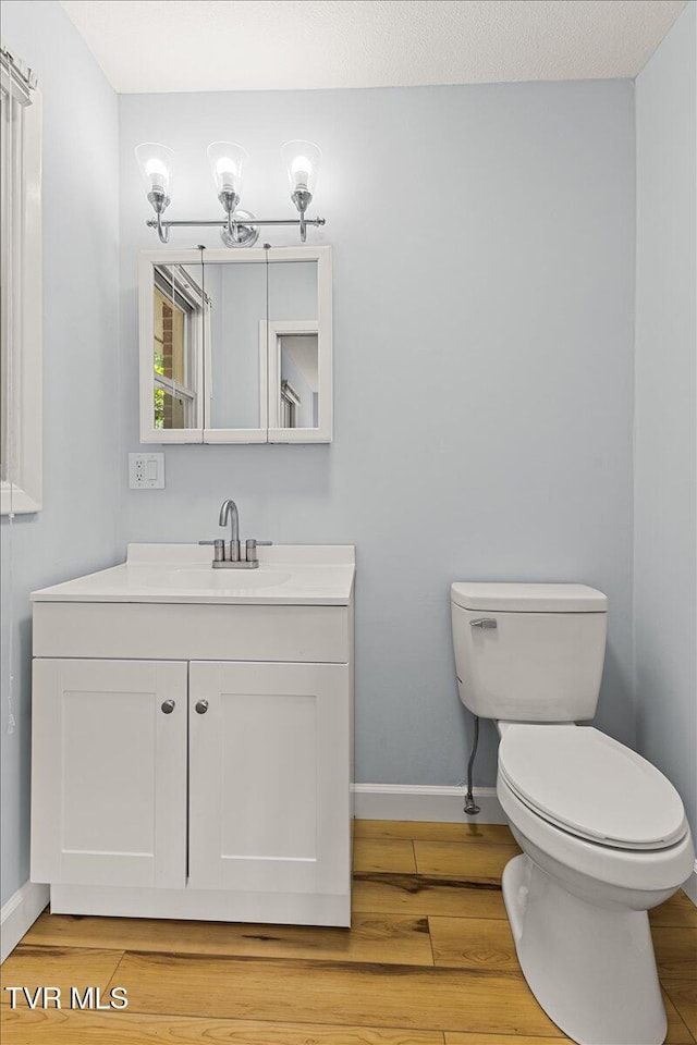 1820 Brook Hollow Rd, Johnson City, TN 37604 - bathroom featuring vanity, toilet, wood finished floors, and baseboards