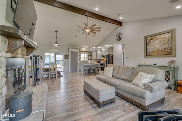 325 Barren Rd, Chuckey, TN 37641 - living area with a ceiling fan, beam ceiling, light wood-style flooring, a fireplace, and high vaulted ceiling