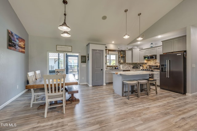 325 Barren Rd, Chuckey, TN 37641 - kitchen featuring high end fridge, vaulted ceiling, stainless steel microwave, a center island, and light wood-type flooring