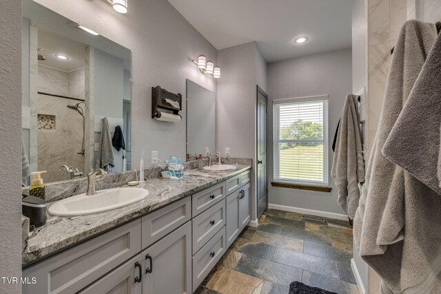 325 Barren Rd, Chuckey, TN 37641 - bathroom featuring double vanity, tiled shower, baseboards, stone tile floors, and recessed lighting