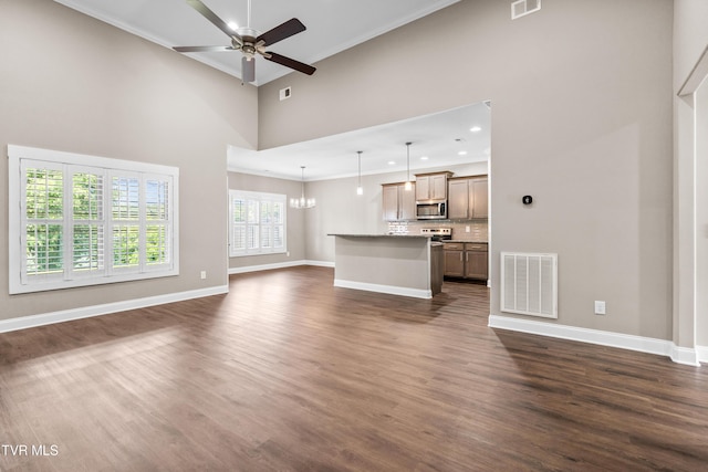 957 Riddle Rdg, Jonesborough, TN 37659 - unfurnished living room with ceiling fan, baseboards, dark wood finished floors, ornamental molding, and a chandelier