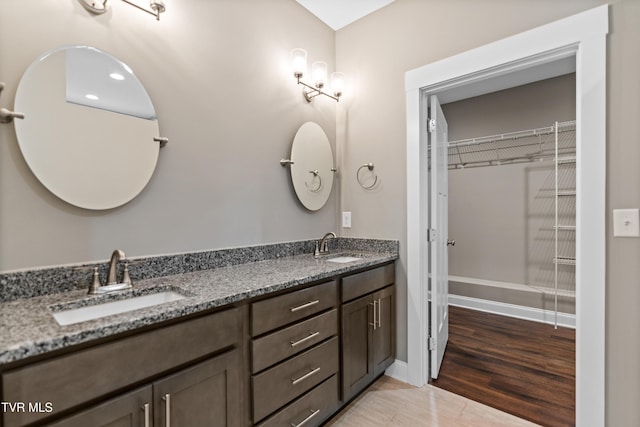 957 Riddle Rdg, Jonesborough, TN 37659 - bathroom featuring double vanity, baseboards, and a walk in closet