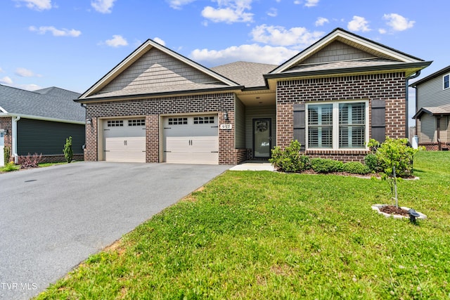 957 Riddle Rdg, Jonesborough, TN 37659 - view of front facade featuring brick siding, a garage, asphalt driveway, and a front yard