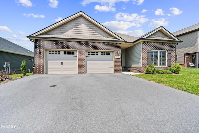 957 Riddle Rdg, Jonesborough, TN 37659 - view of front of home featuring brick siding, an attached garage, driveway, and a front lawn