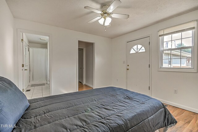 125 Cedar Valley Rd, Bristol, TN 37620 - bedroom with baseboards, light wood-style flooring, a ceiling fan, and ensuite bath