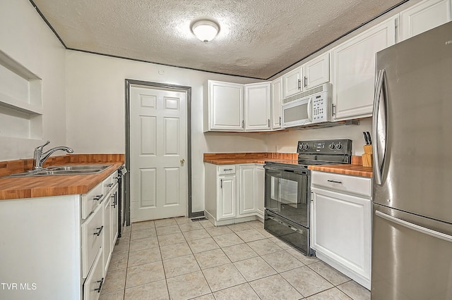 125 Cedar Valley Rd, Bristol, TN 37620 - kitchen featuring freestanding refrigerator, butcher block countertops, electric range, white microwave, and a sink