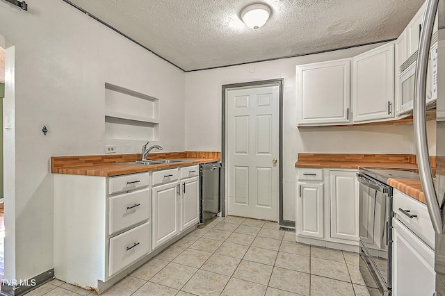 125 Cedar Valley Rd, Bristol, TN 37620 - kitchen with wood counters, a sink, a textured ceiling, white cabinetry, and dishwashing machine