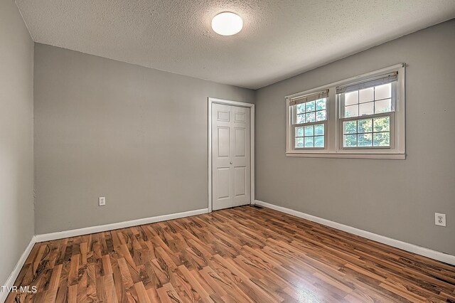125 Cedar Valley Rd, Bristol, TN 37620 - spare room with wood finished floors, baseboards, and a textured ceiling