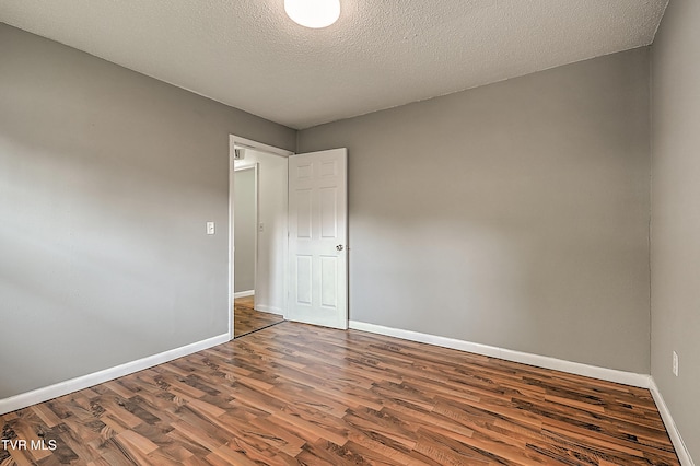 125 Cedar Valley Rd, Bristol, TN 37620 - spare room with wood finished floors, baseboards, and a textured ceiling