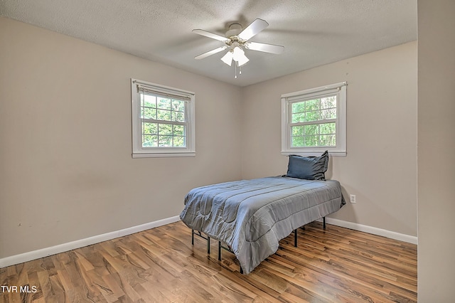 125 Cedar Valley Rd, Bristol, TN 37620 - bedroom featuring multiple windows, wood finished floors, baseboards, a textured ceiling, and a ceiling fan
