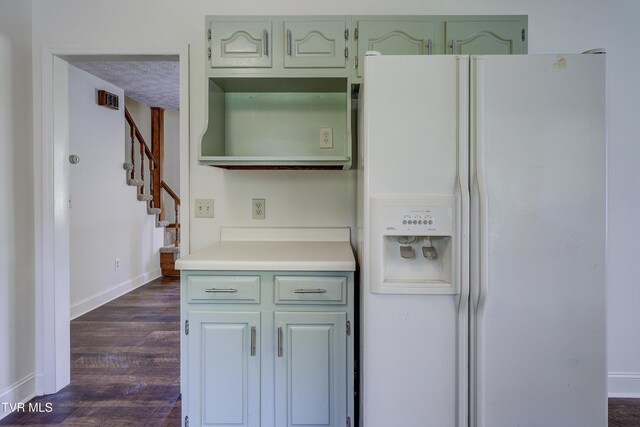 715 Powder Branch Rd, Elizabethton, TN 37643 - kitchen with white fridge with ice dispenser, dark wood-style floors, baseboards, light countertops, and green cabinetry