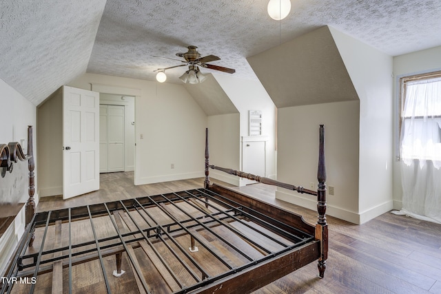 715 Powder Branch Rd, Elizabethton, TN 37643 - additional living space with hardwood / wood-style flooring, a textured ceiling, lofted ceiling, baseboards, and ceiling fan