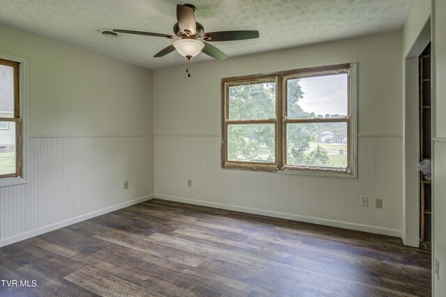 715 Powder Branch Rd, Elizabethton, TN 37643 - empty room featuring dark wood finished floors, a wainscoted wall, ceiling fan, a textured ceiling, and baseboards
