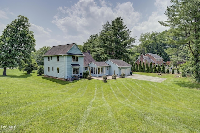 715 Powder Branch Rd, Elizabethton, TN 37643 - rear view of property with an attached garage, a lawn, concrete driveway, and central AC unit