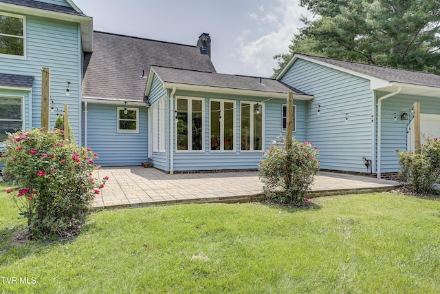 715 Powder Branch Rd, Elizabethton, TN 37643 - rear view of house featuring a patio, a chimney, a lawn, and roof with shingles