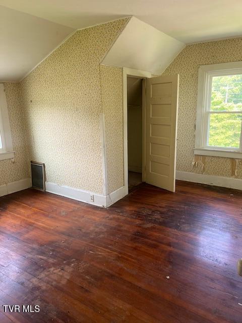 534 Ohio Ave, Erwin, TN 37650 - additional living space featuring vaulted ceiling, hardwood / wood-style flooring, plenty of natural light, wallpapered walls, and baseboards