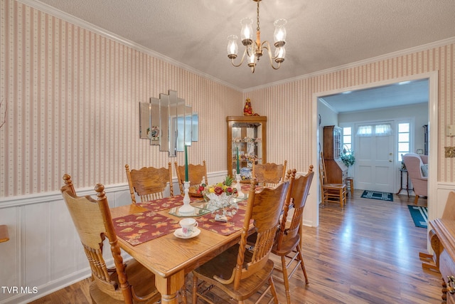 396 High Cir, Bristol, TN 37620 - dining space with crown molding, wallpapered walls, wood finished floors, a chandelier, and a textured ceiling