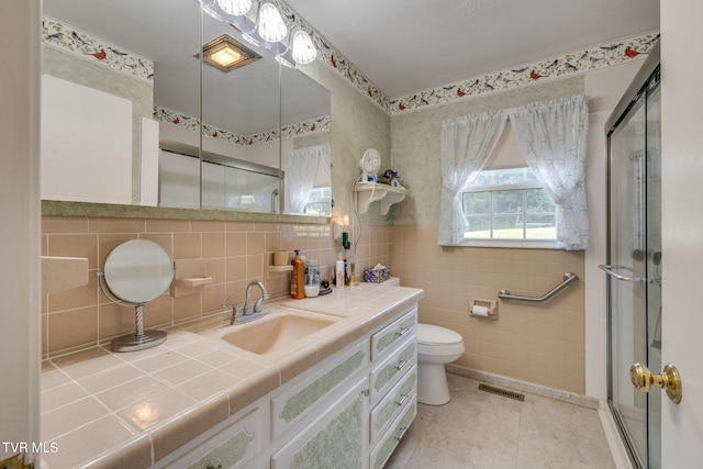 396 High Cir, Bristol, TN 37620 - bathroom with a shower stall, vanity, tile patterned flooring, and tile walls