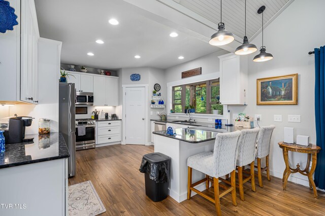 271 Laurel Way, Mountain City, TN 37683 - kitchen featuring stainless steel appliances, a sink, a peninsula, white cabinets, and dark wood-style flooring