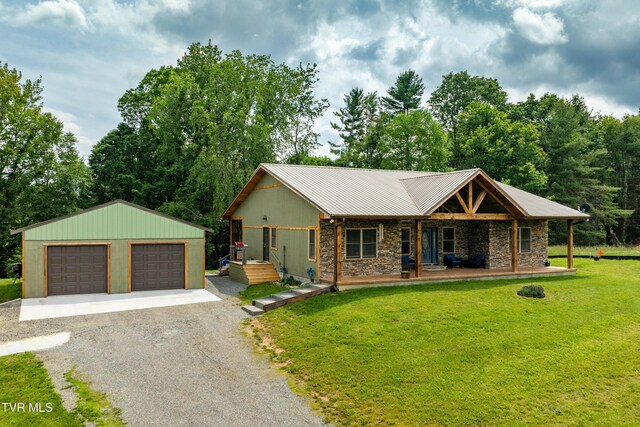 271 Laurel Way, Mountain City, TN 37683 - view of front facade with an outdoor structure, a front lawn, a porch, a garage, and stone siding