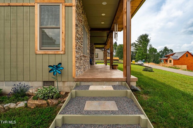 271 Laurel Way, Mountain City, TN 37683 - property entrance with covered porch, a lawn, stone siding, and crawl space