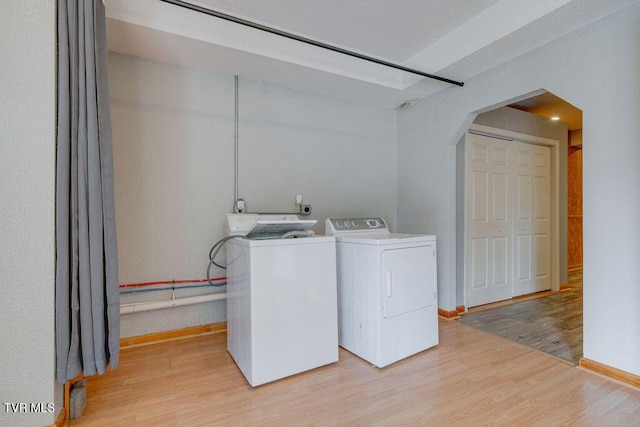 229 Ridgecrest Rd, Jonesborough, TN 37659 - washroom with arched walkways, washer and clothes dryer, light wood-style floors, and baseboards