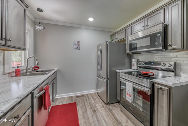 105 Crossway Rd, Bristol, VA 24201 - kitchen with stainless steel appliances, a sink, tasteful backsplash, light wood-style floors, and ornamental molding