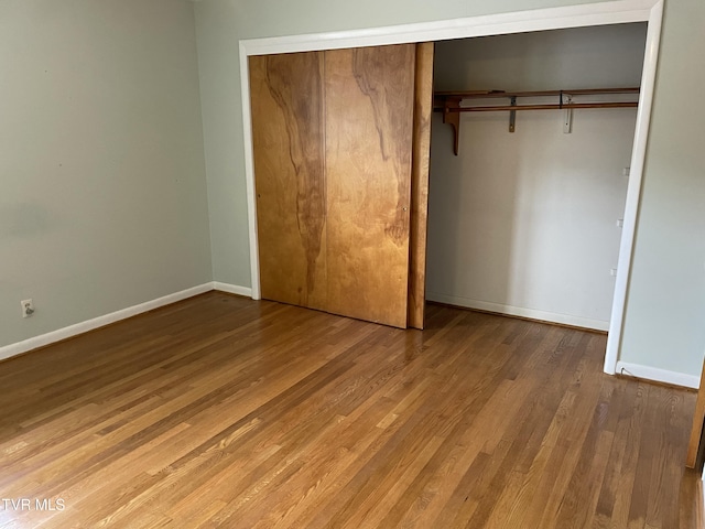 201 Brown St, Appalachia, VA 24216 - unfurnished bedroom featuring wood finished floors, a closet, and baseboards