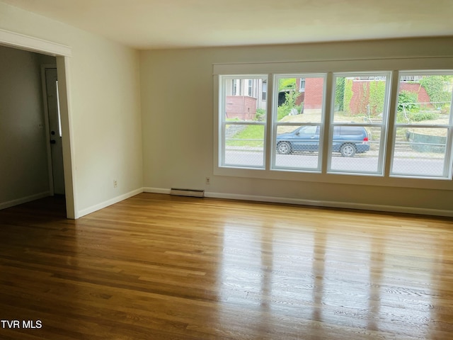 201 Brown St, Appalachia, VA 24216 - unfurnished room with baseboard heating, wood finished floors, and baseboards