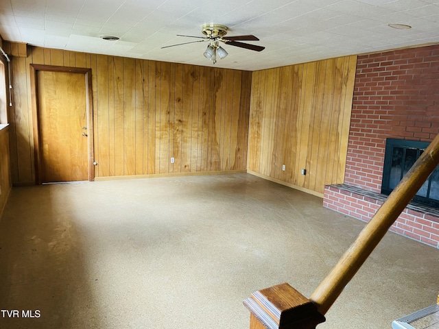 201 Brown St, Appalachia, VA 24216 - unfurnished living room with ceiling fan, wooden walls, a brick fireplace, and baseboards