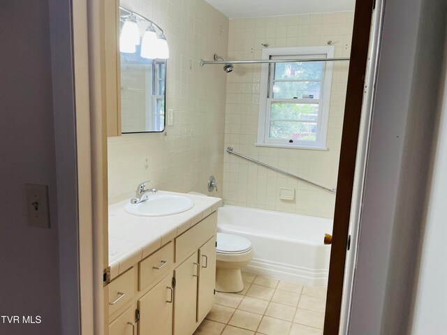 201 Brown St, Appalachia, VA 24216 - full bath featuring vanity, toilet, tile patterned flooring, shower / tub combination, and tile walls