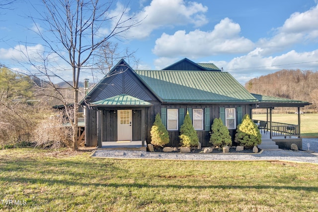 136 Beecher Holtsclaw Rd, Roan Mountain, TN 37687 - view of front of house with a front yard, a porch, and metal roof