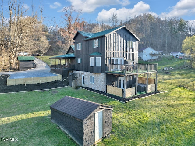 136 Beecher Holtsclaw Rd, Roan Mountain, TN 37687 - back of house featuring metal roof, a deck, board and batten siding, a standing seam roof, and stone siding