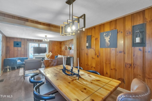 136 Beecher Holtsclaw Rd, Roan Mountain, TN 37687 - dining room with a chandelier, wood walls, and wood finished floors