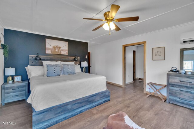 136 Beecher Holtsclaw Rd, Roan Mountain, TN 37687 - bedroom featuring a wall mounted AC, wood finished floors, ornamental molding, a ceiling fan, and baseboards
