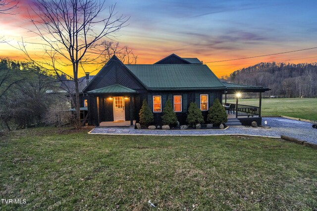 136 Beecher Holtsclaw Rd, Roan Mountain, TN 37687 - view of front of house with a porch, a yard, and metal roof