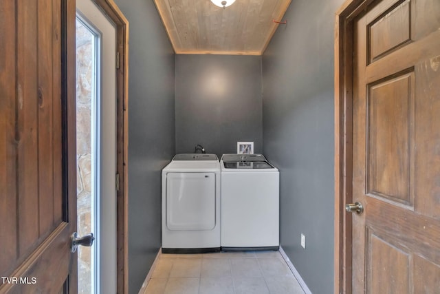 136 Beecher Holtsclaw Rd, Roan Mountain, TN 37687 - washroom featuring washer and clothes dryer, baseboards, ornamental molding, and light tile patterned floors