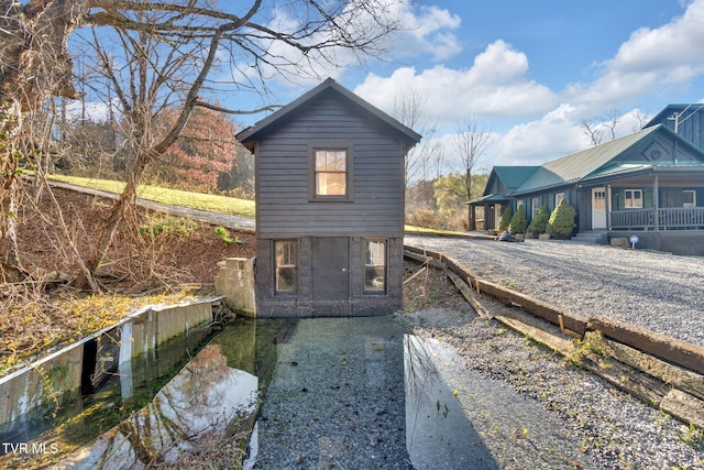 136 Beecher Holtsclaw Rd, Roan Mountain, TN 37687 - rear view of property featuring covered porch