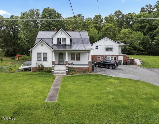 1809 Field Rd, Elizabethton, TN 37643 - view of front of home featuring a porch, a chimney, a front lawn, and metal roof