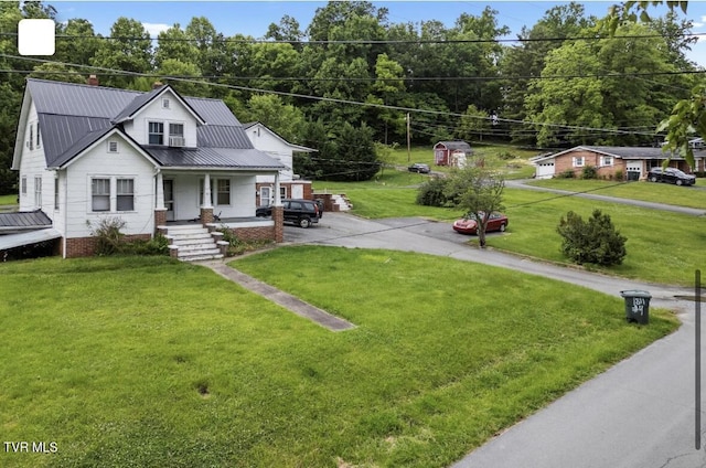1809 Field Rd, Elizabethton, TN 37643 - view of front of property with a porch, a front yard, asphalt driveway, and metal roof