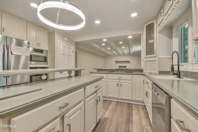 505 Red Oak Ln, Kingsport, TN 37663 - kitchen with appliances with stainless steel finishes, light wood-type flooring, recessed lighting, glass insert cabinets, and a peninsula