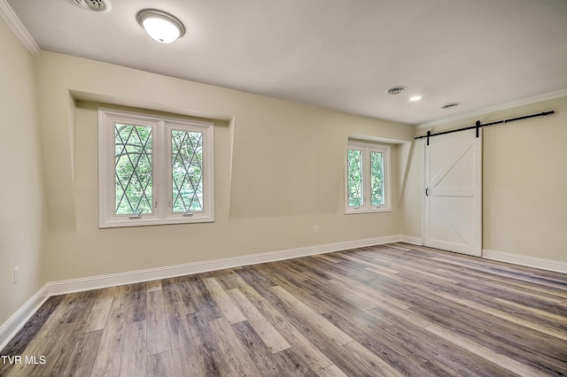 505 Red Oak Ln, Kingsport, TN 37663 - unfurnished bedroom featuring a barn door, wood finished floors, crown molding, and recessed lighting