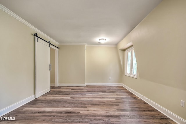 505 Red Oak Ln, Kingsport, TN 37663 - empty room featuring a barn door, ornamental molding, and wood finished floors